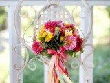 a colorful ribbon wrap and a bow with lots of ribbons is a fun and cute idea for a colorful summer wedding