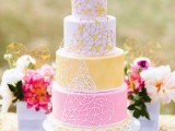 a bright and fun yellow and white wedding cake decorated with geometric hearts is a lovely and bold idea for a modern wedding