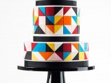a round wedding cake with super colorful triangles covering it and black lines to highlight each tier is a lovely idea for a bold wedding