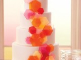 a white round wedding cake decorated with colorful hexagons is a lovely idea for a 70s or a mid-century modern wedding
