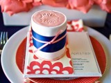 coral blooms, a coral plate and menu and a coral and navy gift box with a bow for each place setting