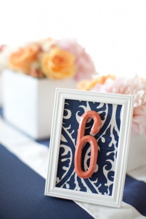 a printed navy and white table number and a coral number itself to highlight the color scheme you've chosen