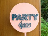 a fun circle coral sign with navy string art showing where to go is a very creative and trendy idea