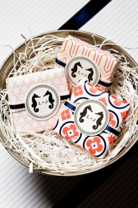 Printed coral napkins with navy napkin rings and monograms are a very fun and cute idea