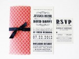 an elegant navy, coral and white wedding invitation suite with a bow and bold lettering