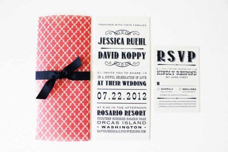 An elegant navy, coral and white wedding invitation suite with a bow and bold lettering