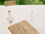 a creative guest book with a wooden cover, which is wood burnt, and usual pages inside