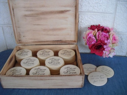 a wooden box with wooden circles, on which the guests will write their wishes and monograms