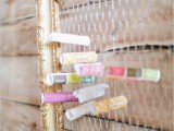 a framed chicken wire piece with colorful papers swirled and tucked inside is ideal for a rustic or woodland wedding