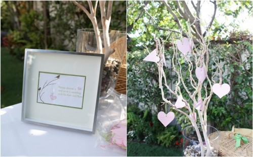 a whitewashed tree with pink hearts that are to be signed by the guests is a creative and fun idea