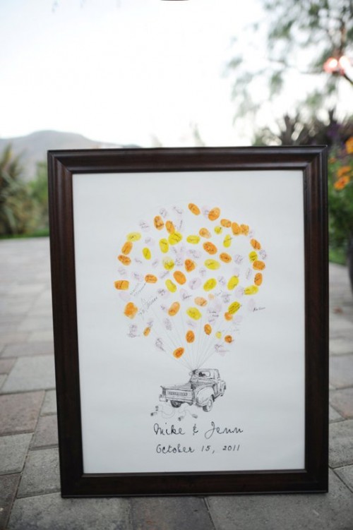 a framed artwork with a truck with colorful balloons that can be signed by the guests is a ready artwork