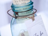 a blue jar with tags that contain wishes from the guests is a simple and very cute idea