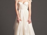 a beautiful a-line wedding dress with a sweetheart neckline, short embellished sleeves and a full skirt