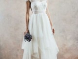 an A-line wedding dress with an illusion neckline, sheer sleeves and a layered skirt looks very eye-catchy