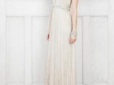 a romantic art deco fully draped wedding dress with lace short sleeves, a deep neckline, an embellished sash and a matching bracelet