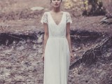 a cool A-line lace wedding dress with a deep V-neckline, lace short sleeves and a short train