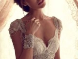 a fully embellished lace wedding dress with cap sleeves, a deep neckline for a bride who wants to sparkle all over