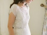an embellished and embroidered fitting wedding dress with short sleeves, an illusion neckline looks refined and really chic