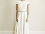 a modern plain wedding dress with a pleated skirt, a high neckline, short sleeves and an embellished sash