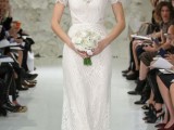a fitting lace wedding dress with short sleeves and a high illusion neckline for a modern bride