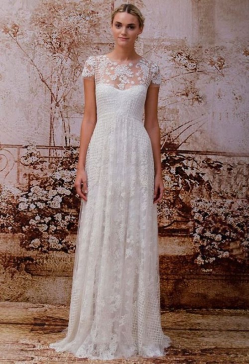 a lace A-line wedding dress with an illusion neckline, short sleeves, a small train for a modern romantic bride