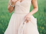 a nude a-line wedding dress with short sleeves, a V-neckline and a draped bodice is a modern take on classics