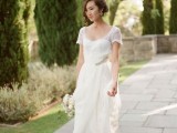 a chic lace A-line wedding dress with a simple neckline, short sheer sleeves and a train