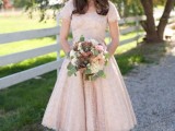 a blush midi floral A-line wedding dress with embellishments and matching shoes plus a birdcage veil
