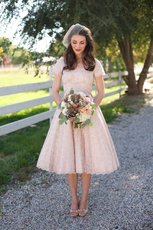 a blush midi floral A line wedding dress with embellishments and matching shoes plus a birdcage veil