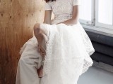 a modern lace A-line wdding dress with a high neckline, short sleeves, blush shoes and statement earrings
