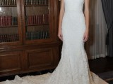 a fitting lace embellished wedding dress with short sleeves, a scoop neckline and a train