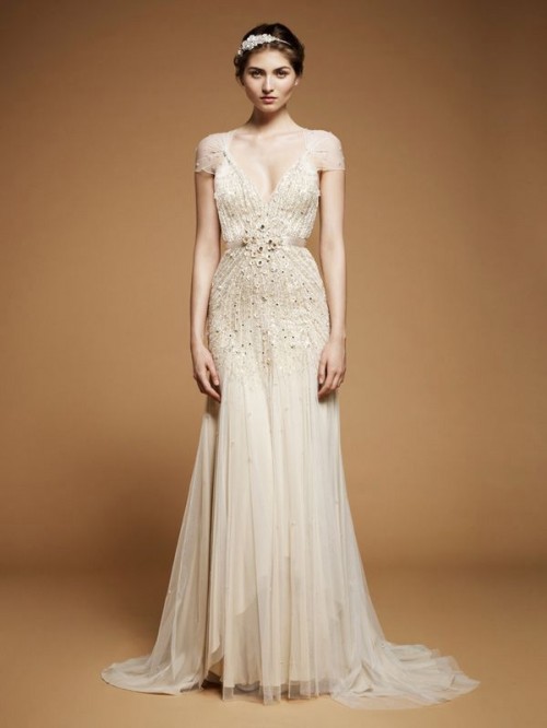 an embellished A-line art decor wedding dress with a deep neckline, cap sleeves and a small train