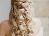 a romantic vintage wedding half updo with a volume on top, a braided halo and waves down is a gorgeous idea