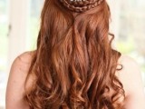 a jaw-dropping half updo with a double braided halo, twists and waves down, an embellished hairpiece for a Queen-like look