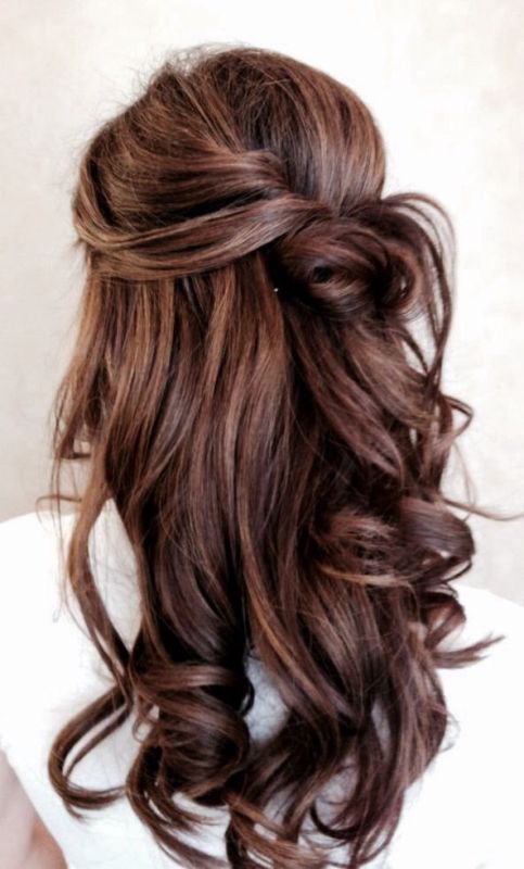 a chic and a bit messy half updo with a volume on top, a messy knot and waves down looks very romantic and lovely