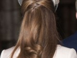 an elegant and chic wedding half updo with a sleek top, twists and straight hair with a bit of locks plus a quirky headpiece