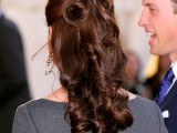 a refined half updo with a volume on top, curls, waves down is an elegant and chic idea