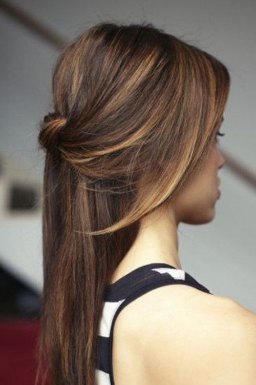 a simple and modern half updo with a volume on top, a twisted knot, side bangs and straight hair down