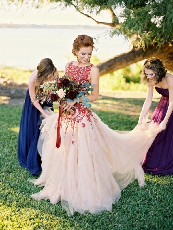A bold blush and red floral embroidery wedding ballgown with a high neckline and no sleeves is a chic idea to try