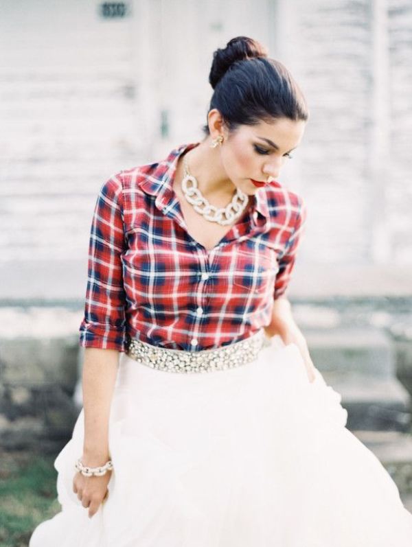 A plaid shirt, a tutu skirt with an embellished sash, a statement chain necklace for a rustic bridal look