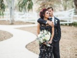 a refined black and white floral lace mermaid wedding dress with no sleeves and an illusion neckline is romantic