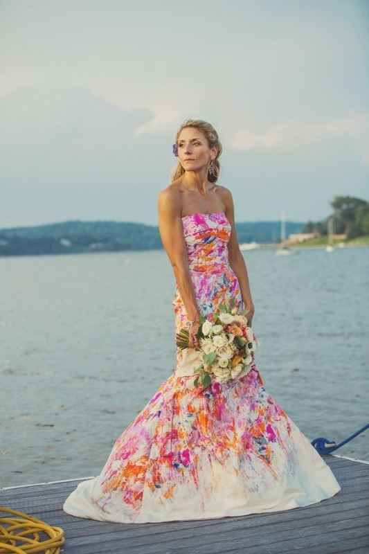 A colorful strapless mermaid wedding dress with bright splashes of various shades is bold and cool