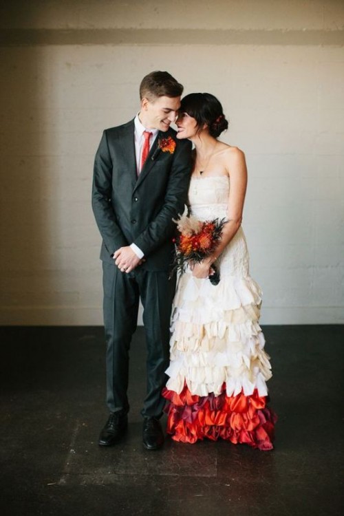 an off the shoulder sheath wedding dress with a draped bodice, a ruffle skirt with a colorful accent