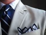 a groom’s or groomsman look with a creamy jacket, a blue shirt, striped tie and handkerchief