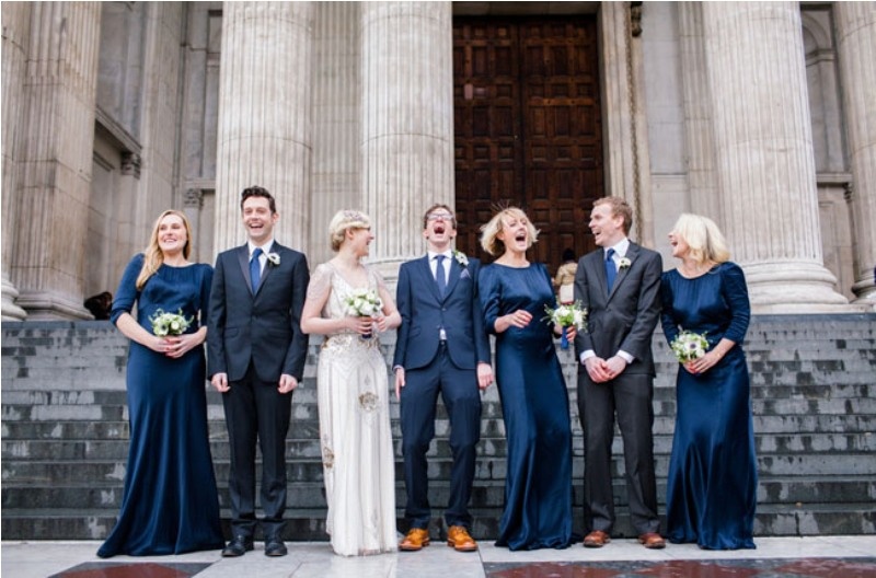 bridesmaids wearign super elegant midnight blue maxi dresses with high necklines and long sleeves