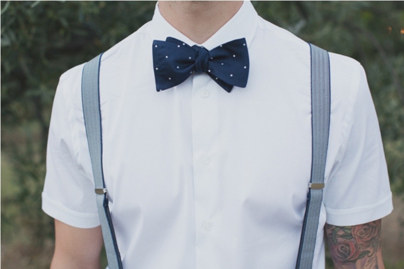 a polka dot midnight blue bow tie is a stylish idea to spruce up your groom's look