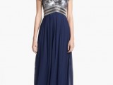 a midnight blue bridesmaid dress with a sequined silver bodice and a maxi pleated skirt