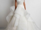 an edgy modern princess style wedding dress with a strapless bodice and ruffles and swirls of fabric for a sculptural shape