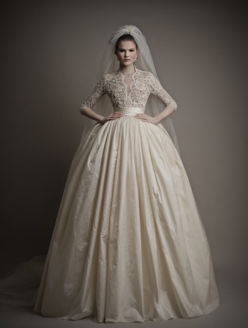 a bold and formal princess style wedding dress with a lace bodice with long sleeves and a full pleated skirt plus a veil is a dreamy and beautiful idea