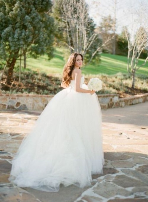 a classic strapless princess style wedding dress with a layered full skirt and a train is a lovely and dreamy idea for a wedding